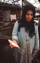 Village woman holding a dead fish near the
Aurul plant